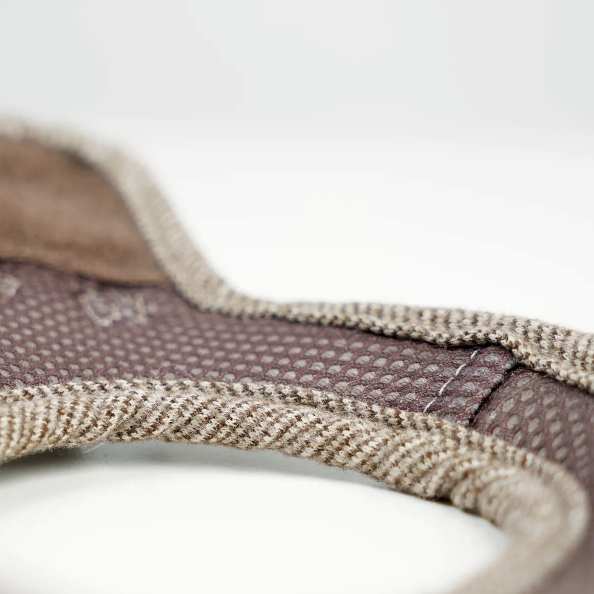 Close-up of the light rose Saga step-in harness laid flat