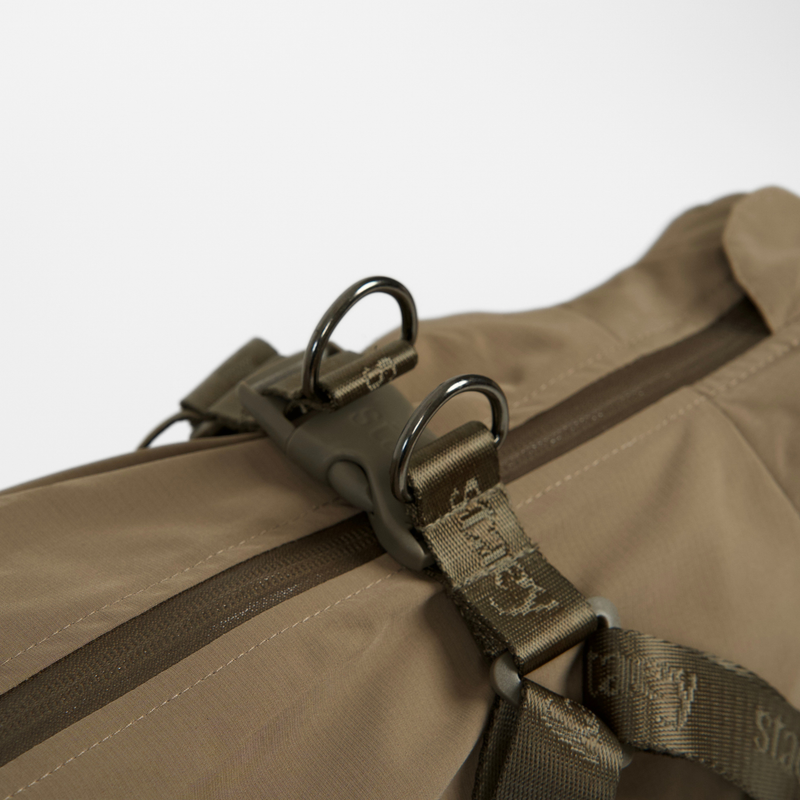 Close-up of the harness straps and D-ring on the taupe rain coat
